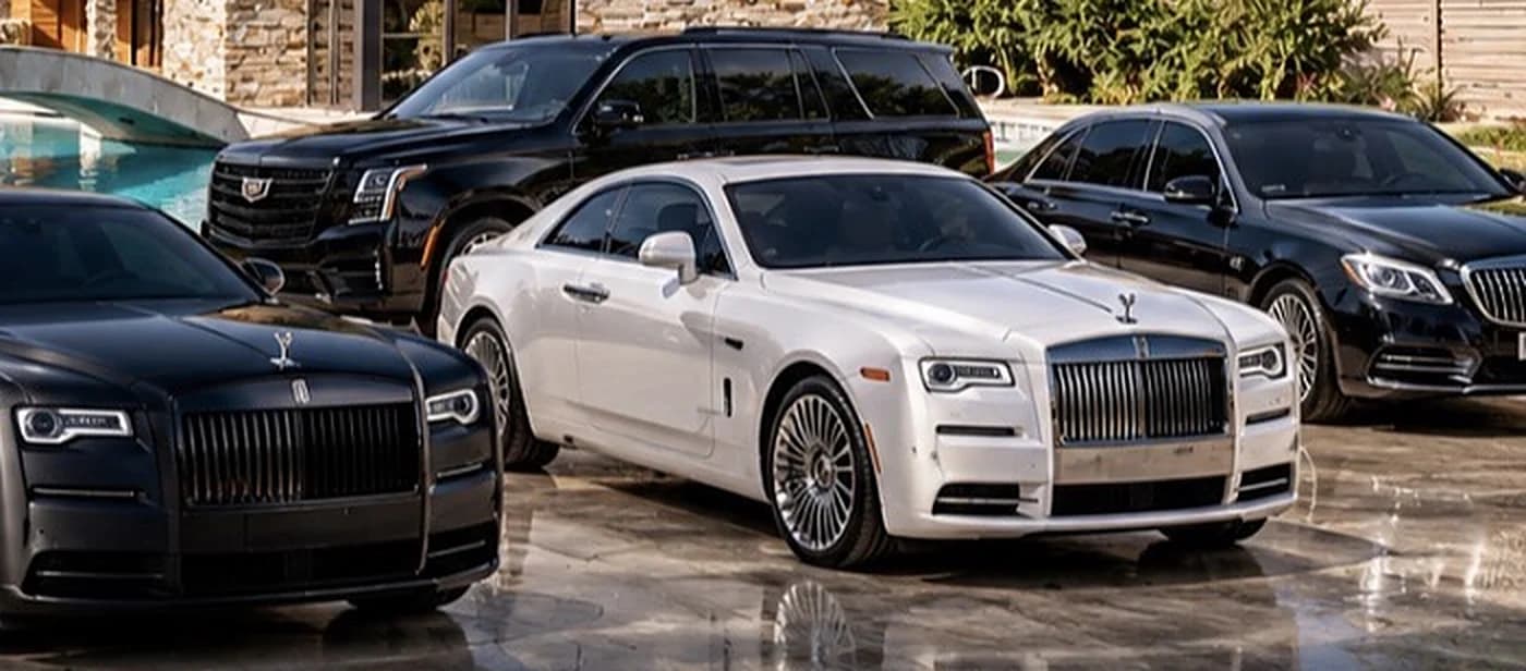 Cadillac Escalade behind the white Rolls-Royce coupé