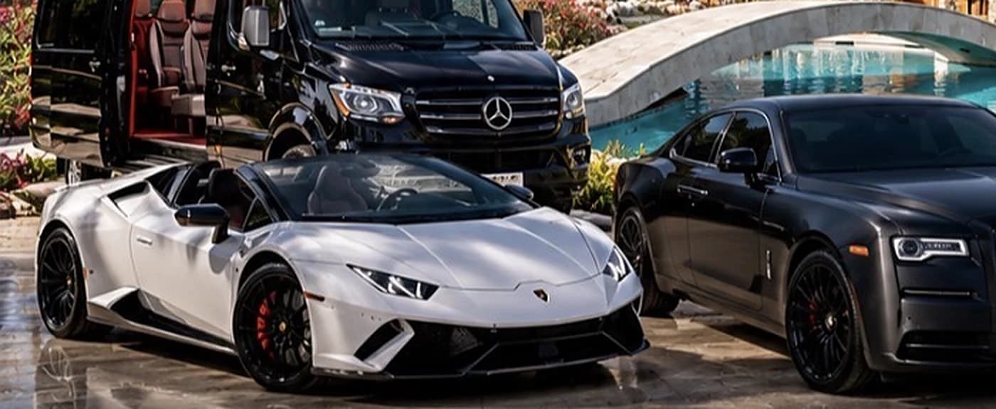 Black Rolls-Royce coupé alongside the white Lamborghini